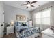 Bright bedroom featuring a floral patterned quilt, soft carpet, and natural light from the window at 40 Ringneck Ct, Lillington, NC 27546