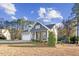 Charming home featuring an attached garage and a covered front porch with rocking chairs at 40 Ringneck Ct, Lillington, NC 27546