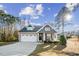 Charming home featuring a covered front porch with rocking chairs and a two-car attached garage at 40 Ringneck Ct, Lillington, NC 27546