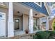 Charming front porch with white columns and rocking chairs, perfect for relaxing outdoors at 40 Ringneck Ct, Lillington, NC 27546