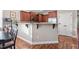 Eat-in kitchen with wood cabinets, a bar, and stainless steel appliances, perfect for casual dining at 40 Ringneck Ct, Lillington, NC 27546