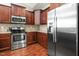 Well-lit kitchen featuring stainless steel appliances, granite countertops, and dark wood cabinetry at 40 Ringneck Ct, Lillington, NC 27546