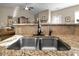 Functional kitchen featuring granite countertops, a stainless steel sink, and an open layout at 40 Ringneck Ct, Lillington, NC 27546