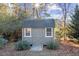 Charming backyard shed with gray siding, a shingled roof, and double door entrance at 40 Ringneck Ct, Lillington, NC 27546