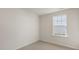 Comfortable bedroom featuring neutral carpet, a window for natural light, and ample electrical outlets at 401 Citron St, Sanford, NC 27332