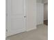 Hallway featuring neutral carpet and white doors leading to various rooms, enhancing the sense of flow and connectivity at 401 Citron St, Sanford, NC 27332