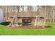 Stone and wooden sign for Laurel Oaks with beautiful landscaping in front of a wooded backdrop at 405 Citron St, Sanford, NC 27332