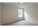 Cozy bedroom with carpet flooring and large window overlooking the backyard at 409 Citron St, Sanford, NC 27332