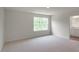 Bedroom featuring plush carpeting, large window and en-suite bathroom at 409 Citron St, Sanford, NC 27332
