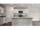 Bright kitchen with white cabinets, granite countertops, stainless steel appliances, and a central island at 409 Citron St, Sanford, NC 27332