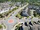 Aerial view of a residential neighborhood, with tree-lined streets, townhomes and a roundabout at 4137 Strendal Dr, Cary, NC 27519