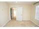 Bedroom featuring neutral carpeting, trim, and walls, and two open doorways leading to other rooms at 4137 Strendal Dr, Cary, NC 27519