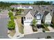 Inviting townhome showcasing an attached garage, lush landscaping, and a paved driveway at 4137 Strendal Dr, Cary, NC 27519