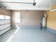 Garage featuring epoxy floors, hot water heater, insulated garage door, and neutral colored walls at 4137 Strendal Dr, Cary, NC 27519