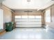 Garage featuring epoxy floors, storage racks, rollaway trash bins, and an insulated garage door at 4137 Strendal Dr, Cary, NC 27519