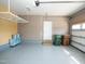 Garage featuring epoxy floors, storage racks, side door, and insulated garage door at 4137 Strendal Dr, Cary, NC 27519