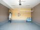 Garage featuring epoxy floors, storage racks, hot water heater, and an electrical panel at 4137 Strendal Dr, Cary, NC 27519