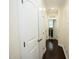 Hallway with wood floors featuring white trim and doors at 4137 Strendal Dr, Cary, NC 27519