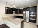 Well-equipped kitchen with granite countertops, stainless steel appliances, dark wood cabinets, and modern lighting at 4137 Strendal Dr, Cary, NC 27519