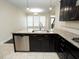 Updated kitchen boasts granite countertops, stainless steel appliances, dark wood cabinets, and tile floors at 4137 Strendal Dr, Cary, NC 27519