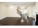 Bright and airy living room with hardwood floors, white trim, and a staircase leading to the second floor at 4137 Strendal Dr, Cary, NC 27519