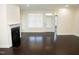 Inviting living room features hardwood floors, a fireplace with white mantel, and a large window at 4137 Strendal Dr, Cary, NC 27519
