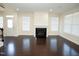 Inviting living room featuring hardwood floors, fireplace, and ample natural light for a cozy space at 4137 Strendal Dr, Cary, NC 27519