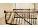 Staircase with decorative iron railing and wood trim leading to carpeted landing at 4137 Strendal Dr, Cary, NC 27519
