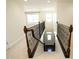 Stairway with decorative metal railing leading to a view of the front entry door and a carpeted hallway at 4137 Strendal Dr, Cary, NC 27519