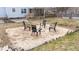 A fire pit with four chairs arranged around it in a backyard in need of some landscape work at 415 Moonlight Dr, Fuquay Varina, NC 27526