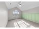 Spacious bedroom with a large window and vaulted ceilings, perfect for relaxation at 415 Moonlight Dr, Fuquay Varina, NC 27526