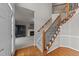 Bright foyer with hardwood floors, staircase with iron railings, and view into living room at 415 Moonlight Dr, Fuquay Varina, NC 27526