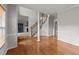 Hardwood foyer with staircase and view into carpeted living room with fireplace at 415 Moonlight Dr, Fuquay Varina, NC 27526