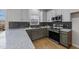 Renovated kitchen featuring stainless steel appliances and stylish backsplash at 415 Moonlight Dr, Fuquay Varina, NC 27526