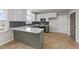 Open kitchen features stainless steel appliances and ample counter space with stylish flooring at 415 Moonlight Dr, Fuquay Varina, NC 27526