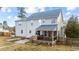 Rear exterior featuring a screened porch and garden beds, creating an inviting outdoor space at 415 Moonlight Dr, Fuquay Varina, NC 27526