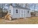 A backyard shed featuring double doors and a small ramp for entry, great for storage at 415 Moonlight Dr, Fuquay Varina, NC 27526