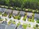 Aerial view of homes in a residential neighborhood with tree lined streets and sidewalks at 428 Morgan Ridge Rd, Holly Springs, NC 27540