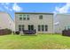 Spacious backyard with a patio, lush green lawn, and privacy fence at 428 Morgan Ridge Rd, Holly Springs, NC 27540