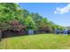 Large backyard with a fence, storage shed, and landscaping at 428 Morgan Ridge Rd, Holly Springs, NC 27540