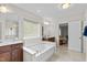 Large bathroom with a soaking tub, double vanities, and plenty of space for relaxation at 428 Morgan Ridge Rd, Holly Springs, NC 27540