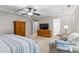 Spacious bedroom with tray ceilings, ceiling fan, and a sitting area, offering a versatile layout at 428 Morgan Ridge Rd, Holly Springs, NC 27540