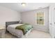 Neutral bedroom features a large window, carpet, and light-colored walls for a calm atmosphere at 428 Morgan Ridge Rd, Holly Springs, NC 27540