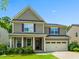Inviting two-story home featuring a covered front porch, neutral siding, and a two-car garage at 428 Morgan Ridge Rd, Holly Springs, NC 27540