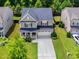 Charming two-story home with a well-manicured lawn and a spacious two-car garage at 428 Morgan Ridge Rd, Holly Springs, NC 27540