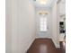 Clean hallway features wood floors and a well-lit doorway, enhancing the home's aesthetic at 428 Morgan Ridge Rd, Holly Springs, NC 27540