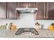 Granite countertops and white subway tile backsplash highlight this modern kitchen at 428 Morgan Ridge Rd, Holly Springs, NC 27540