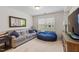Comfortable living room featuring a large couch, beanbag, and natural light from a window at 428 Morgan Ridge Rd, Holly Springs, NC 27540