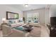 Bright and airy living room with plush seating, a large window, and stylish decor at 428 Morgan Ridge Rd, Holly Springs, NC 27540