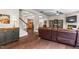 Open-concept living area with hardwood floors, a comfortable sectional, and ample natural light at 428 Morgan Ridge Rd, Holly Springs, NC 27540